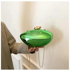 Close-up of green acrylic mango clutch bag with gold chain and glossy mirror finish