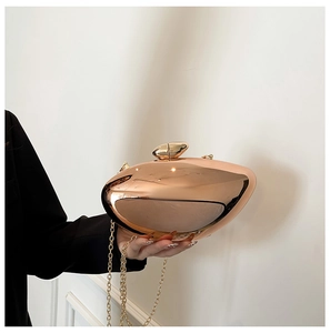Detailed macro of rose gold mirror acrylic evening bag with pebble lock and metal chain