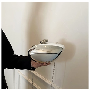 Polished silver pebble-shaped acrylic clutch with metallic chain strap and pebble clasp