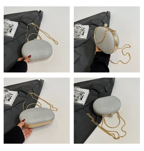 Detail of silver glitter clutch bag with gold metal frame and detachable chain strap