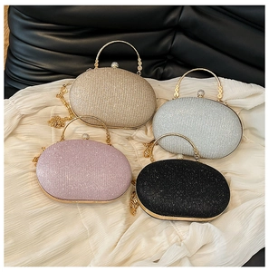 Top view of four glittery oval evening bags in gold, silver, pink, and black colors