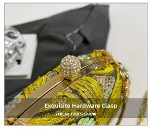 Macro shot of gold rhinestone ball clasp on sequined evening clutch bag detail