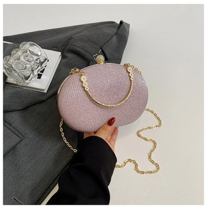 Pink sequin hard shell evening bag with golden floral handle and pearl clasp detail