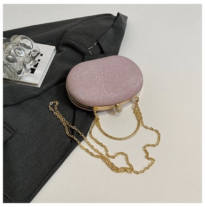 Pink glitter box clutch bag with gold ring handle and diamond spherical lock close-up