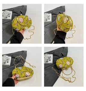 Detail of floral sequin embroidery and pearl rhinestone clasp on yellow evening bag