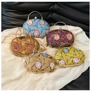 Detailed view of floral sequined evening bags in multiple colors with gold ring handles