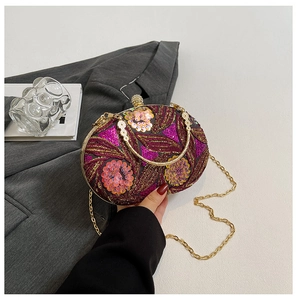 Detail shot of vintage evening bag showing intricate purple floral sequins and embroidery