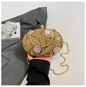 Detailed close-up of colorful floral sequins and golden embroidery on an elegant evening bag