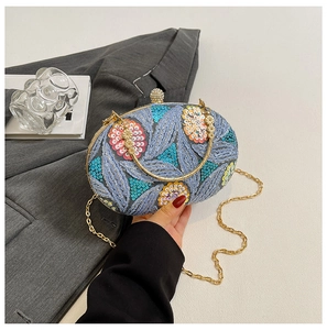 Detail of sequins embroidery on evening bag with floral patterns and diamond clasp