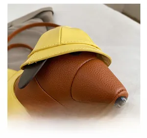 Detailed macro view of creative dachshund shoulder bag with yellow and brown faux leather