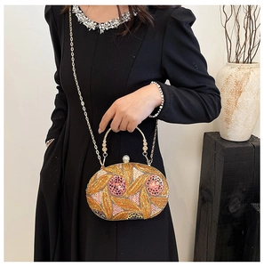 Detailed view of an oval evening bag with hand-sewn sequins and floral bead patterns
