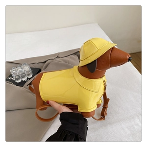 Macro shot of dachshund crossbody bag with yellow raincoat design and pebbled brown leather