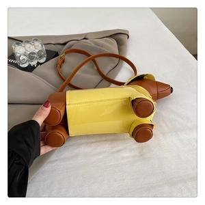 Detail of whimsical dachshund-shaped shoulder bag featuring yellow and brown faux leather