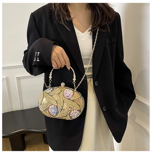 Detail of luxury sequin embroidered evening bag with gold ring handle and chain strap