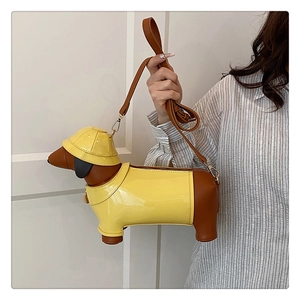 Detail of creative dachshund shaped shoulder bag in bright yellow and brown faux leather