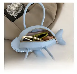 Internal view of blue dolphin bag showing capacity for phone and accessories
