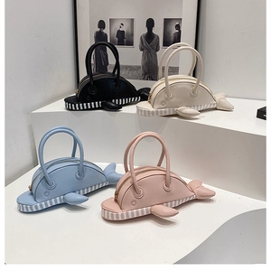 Detail shot of creative whale-shaped handbags in four colors with smooth PU leather finish