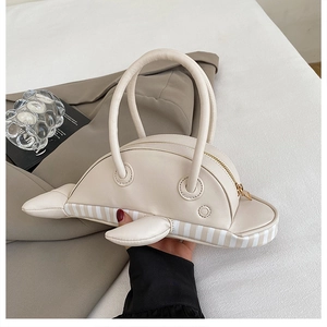 Detailed view of creative dolphin handbag in cream leather with gold zipper accents