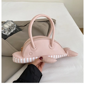 Detailed close-up of a pink dolphin-shaped handbag with a striped base and zipper closure