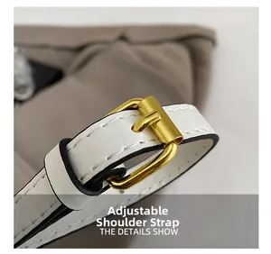 Detailed view of adjustable white leather strap with golden buckle and precision stitching
