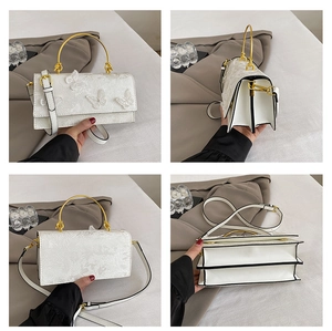 Detailed multi-angle view of a white lace handbag with 3D butterfly charms and gold hardware