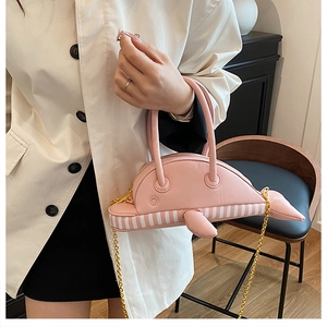 Detailed view of pink dolphin creative bag with golden chain and striped belly
