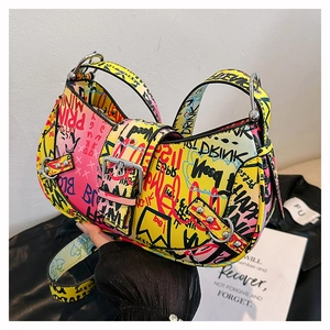 Detail of colorful graffiti letters and silver buckle on a stylish leather hobo bag