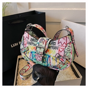 Detailed view of colorful graffiti prints and metal buckle on this half-moon bag