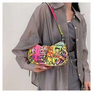 Detail of trendy graffiti print shoulder bag with silver buckle and adjustable strap