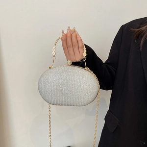 Sparkling silver evening clutch bag with gold flower handle and detachable chain strap