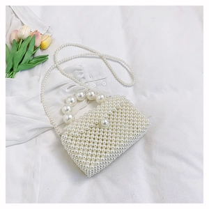 Vue détaillée du sac à main en perles blanches avec poignée et bandoulière élégante