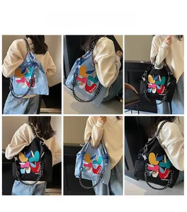 Detailed views of embroidered canvas tote bag with contrast polka dot rope straps