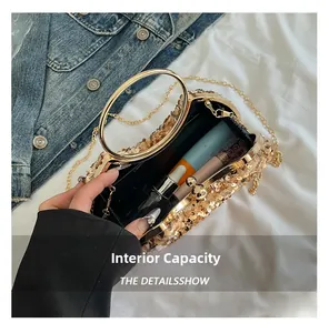 Detail view of champagne sequin evening clutch showing inner capacity for cosmetics