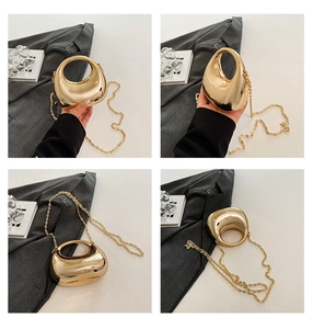Detail view of mini gold pebble bag with mirror finish and stylish chain strap