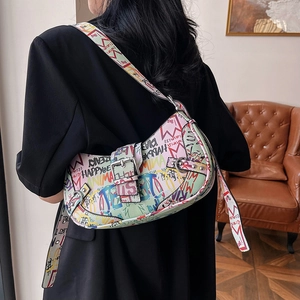 Graffiti printed half-moon shoulder bag in green leather with colorful urban lettering