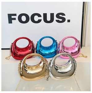 Symmetric display of glossy acrylic dumpling bags with metallic finish and gold chains