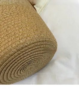 Detailed close-up of handmade natural fiber weaving and spiral texture on the bucket bag