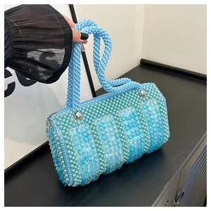 Detail of blue pearl beaded handbag with sequin fish-scale pattern and metal zipper