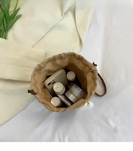 Top view of woven drawstring bucket bag showing spacious interior with phone and cosmetics