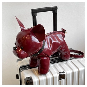 Detail of burgundy French bulldog crossbody bag with glossy finish and rivet collar