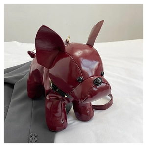 Detail of burgundy bulldog cross body bag with glossy finish and metal stud collar