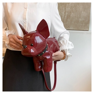 Detail of creative burgundy bulldog crossbody bag with shiny finish and gold stud collar