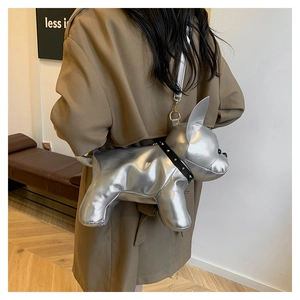 Detail of silver metallic bulldog crossbody bag with rivet collar worn by a model