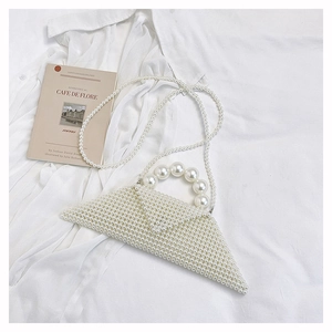 Detail of white pearl woven triangular bag with beaded handle and shoulder strap