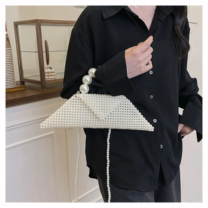 Detail of a triangle woven pearl handbag with large bead handle and chain shoulder strap
