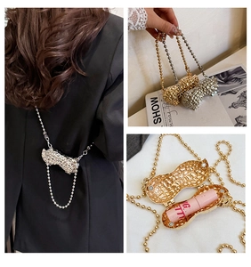 Detail view of peanut-shaped mini metal crossbody bag for lipstick with珠链 chain strap