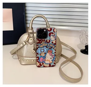 Detail view of mini shell bag with rivet base shown next to a smartphone for size scale