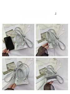 Silver mini crossbody bag with crocodile texture and phone for size comparison