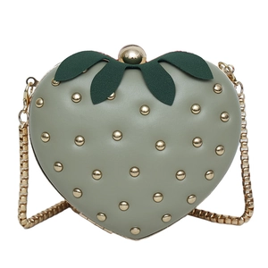 Sweet strawberry shaped crossbody bag with gold rivets and metallic chain strap