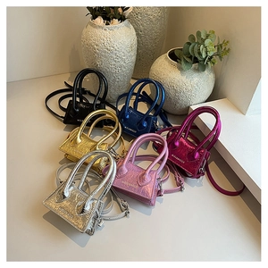 Group display of micro trapezoid bags in six metallic colors with leather texture and straps